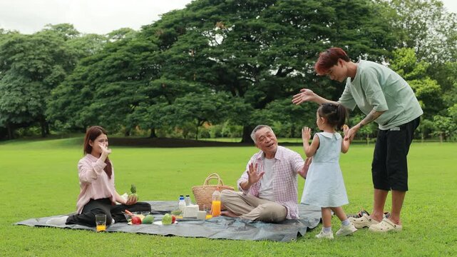 Father, Little girl walking and spending time with father in the park. Happy Asian family having fun time on picnic at city nature park, outdoor activitie