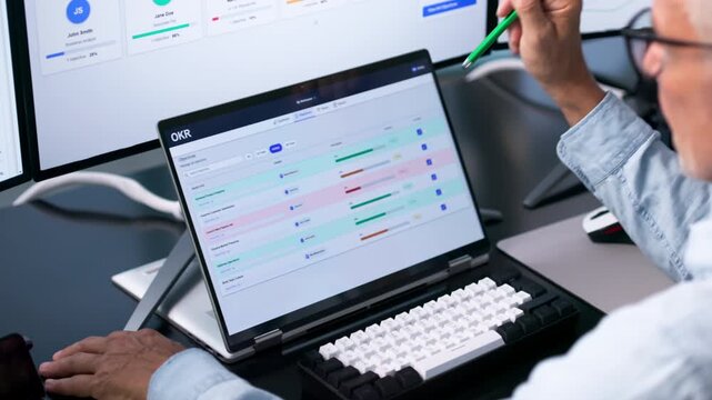 Business Analyst Reviews Key Results On Laptop