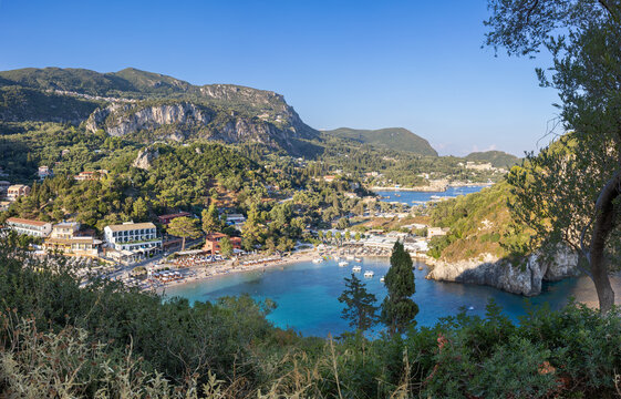 Looking down to Paleokastritsa beach and bay on the island of Corfu, Greece. Unidentifiable people on the beach.