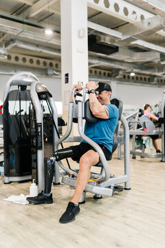 Man with prosthetic leg exercising in gym