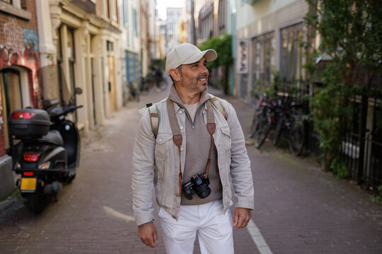 Male Traveler Walking Down Alley in Amsterdam Netherlands