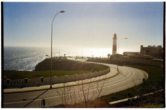 Curved coastal road with lighthouse