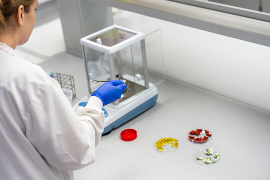 Lab Technician Measures Substances for Analysis at Laboratory