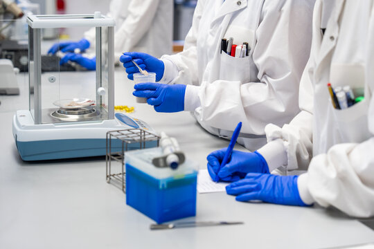 Researchers Conduct Experiments in a Laboratory With Equipment