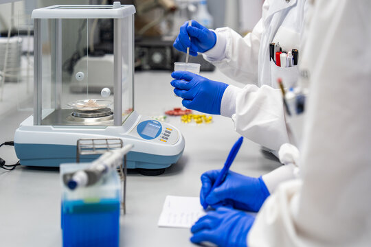 Lab Workers Conduct Tests Using Equipment and Samples in a Laboratory