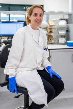 Scientist Sitting in Laboratory With Gloves and Lab Coat