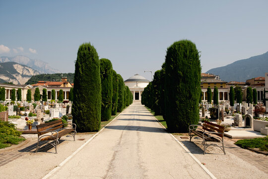 Monumental cemetery pathway with cypress trees in Trento