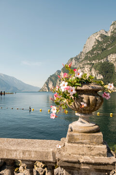 Flower planter overlooking Lake Garda and mountain landscape, italy