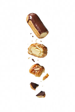 Eclairs and pastries falling through air.