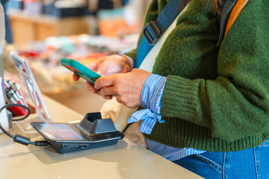 person using cell phone tap to pay