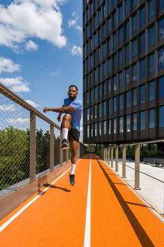 Man Warming Up In Modern Architecture Background