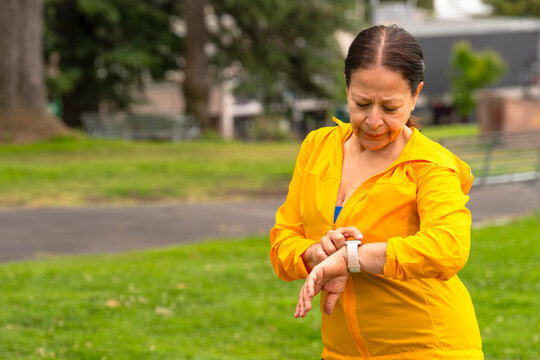 active woman checking smartwatch fitness tracker watch