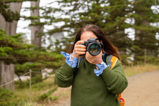 photographer holding camera taking photo