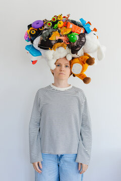 A large ball of toys on a woman's head