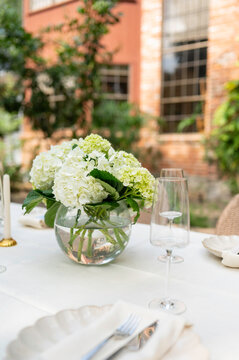 Flowers Arranged in a Glass Vase on a Rustic Dining Table