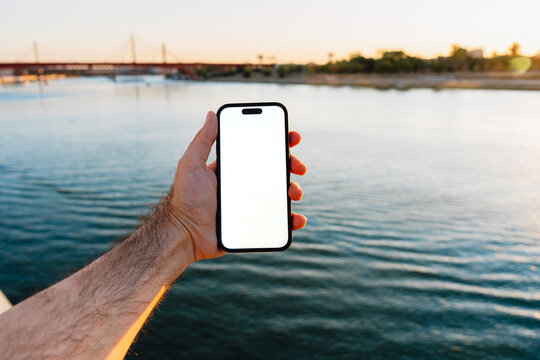 White Screen Phone at a Riverside Bridge