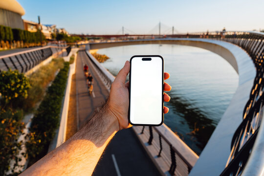 White Screen Phone at a Riverside Bridge