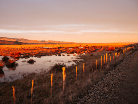 Fenceline Along Wetland at Sunset