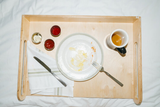 Finished empty plate hotel breakfast in bed