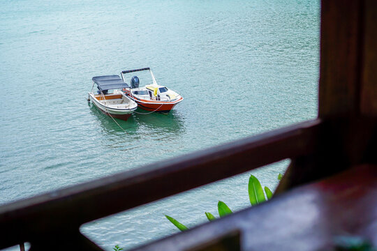 Tropical boat trip in Sabang island, Indonesia. Idyllic scene tropical vacation seaside. Motor sailing ship ocean blue water.