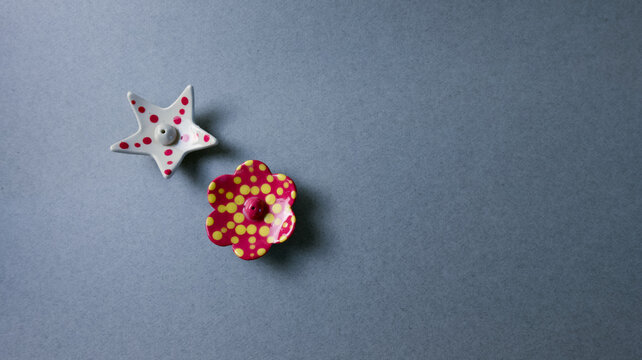 Two charming ceramic incense holders, one shaped like a star and another like a flower, both featuring playful polka dot patterns. This bright image is ideal for lifestyle, home decor, or craft-relate