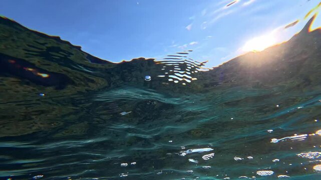 Sunlight shimmering through a rippling water surface