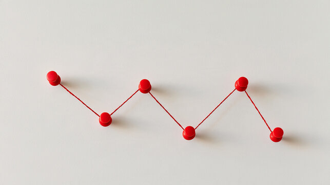 String pinned between push pins forms a downward zigzag line across a bright board surface crisp thread detail soft shadows minimal tactile composition market decline financial