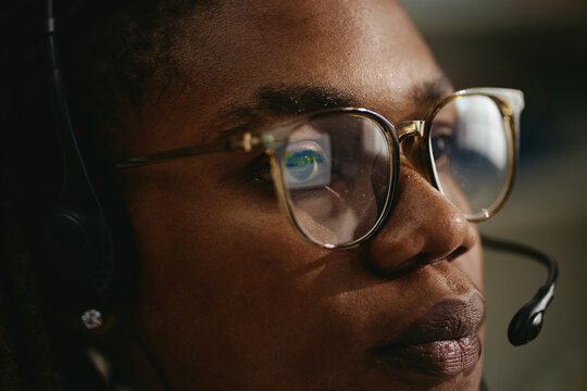 Close up of African American young adult male pediatrician wearing headset and glasses during telemedicine consultation. Ideal for healthcare campaigns and online pediatric services