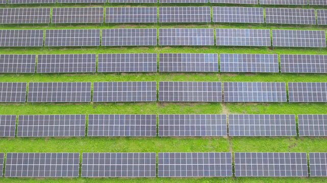 Top-Down Aerial Close-Up View of Solar PV Panel Array on Zoige Grassland: Renewable Clean Energy, Agrivoltaics, Green Field and Sunlight Background