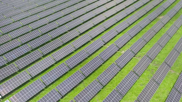 Top-Down Aerial Close-Up View of Solar PV Panel Array on Zoige Grassland: Renewable Clean Energy, Agrivoltaics, Green Field and Sunlight Background