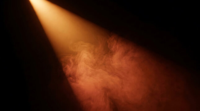 Warm spotlight illuminating swirling smoke on dark background