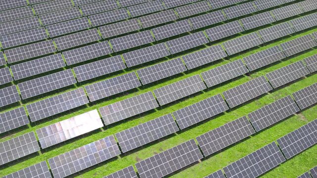 Top-Down Aerial Close-Up View of Solar PV Panel Array on Zoige Grassland: Renewable Clean Energy, Agrivoltaics, Green Field and Sunlight Background