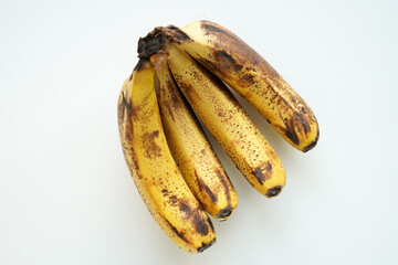 Overheard view of overripe yellow bananas isolated on white © honey