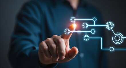 Obraz premium Finger touching glowing circuit board lines and nodes, representing technological connection.
