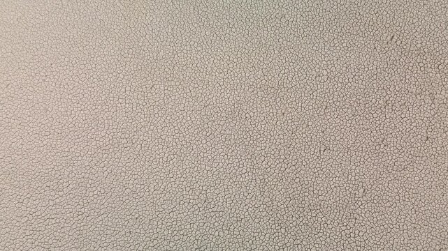 Drone top down view of cracked dry soil on dried reservoir bottom, global warming and severe drought texture background