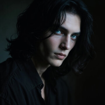 Dramatic Portrait of Young Aristocratic Man with Dark Wavy Hair and Piercing Blue Eyes