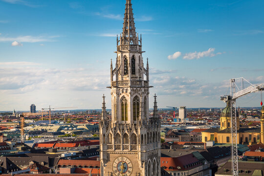 Munich New Town Hall and Marienplatz Aerial View at sunset. Ornate Gothic architecture, distinctive clock tower, surrounding historic buildings, and vibrant city square. Germany