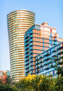 London Canary Wharf Skyscrapers at Sunset. The scene captures the scale and character of London's residential buildings with multiple windows and balconies 