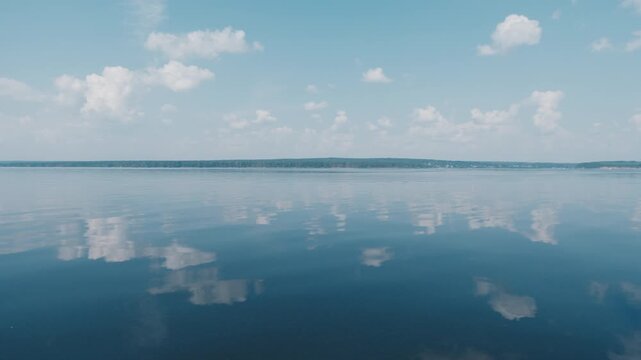 Calm lake surface during sunny summer day