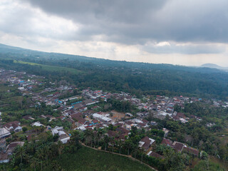 Obraz premium Aerial panorama of Wonosari tropical hillside settlement, cultivated fields