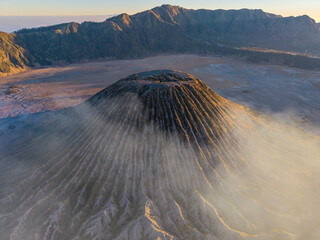Aerial drone panorama of Gunung Batok dead volcano, rugged volcanic slopes, barren caldera, and surrounding highland forest. © Cloudyew