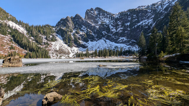 Reflection of Snow Covered Cliffs at Heather Lake in Washington State