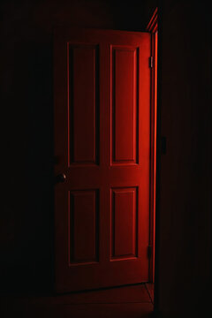 Mysterious doorway with bright red illumination. Scary backdrop