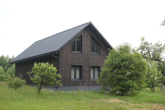 Cozy wood scandinavian house in sunny day in summer