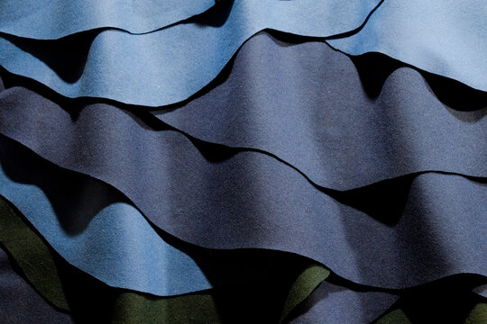 Wavy pattern of different tones of blue fabric 