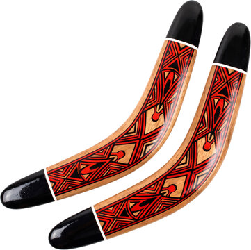 Pair of wooden boomerangs with red tribal pattern isolated on white