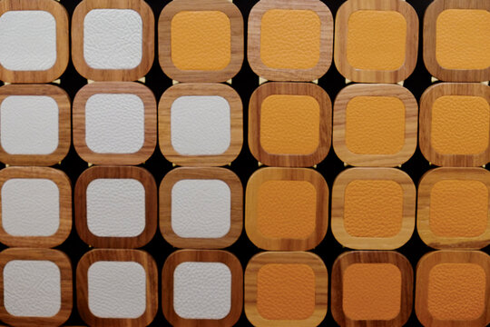Wood and leather framed square tiles in rows
