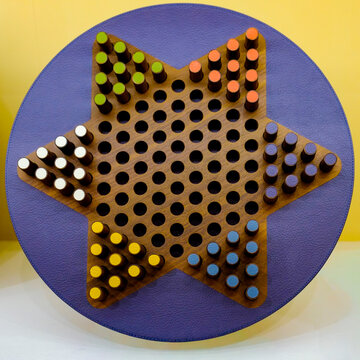 Chinese checkers board with colored pegs