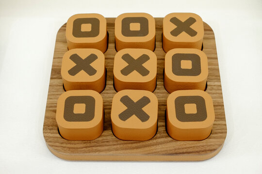 Tic-tac-toe game pieces with X and O on board