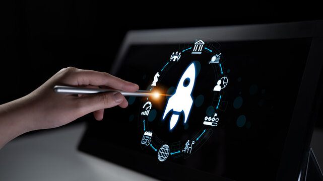 A hand holds a stylus touching a digital screen displaying a rocket icon, symbolizing innovation, technology advancement, and business process management growth. Nascent